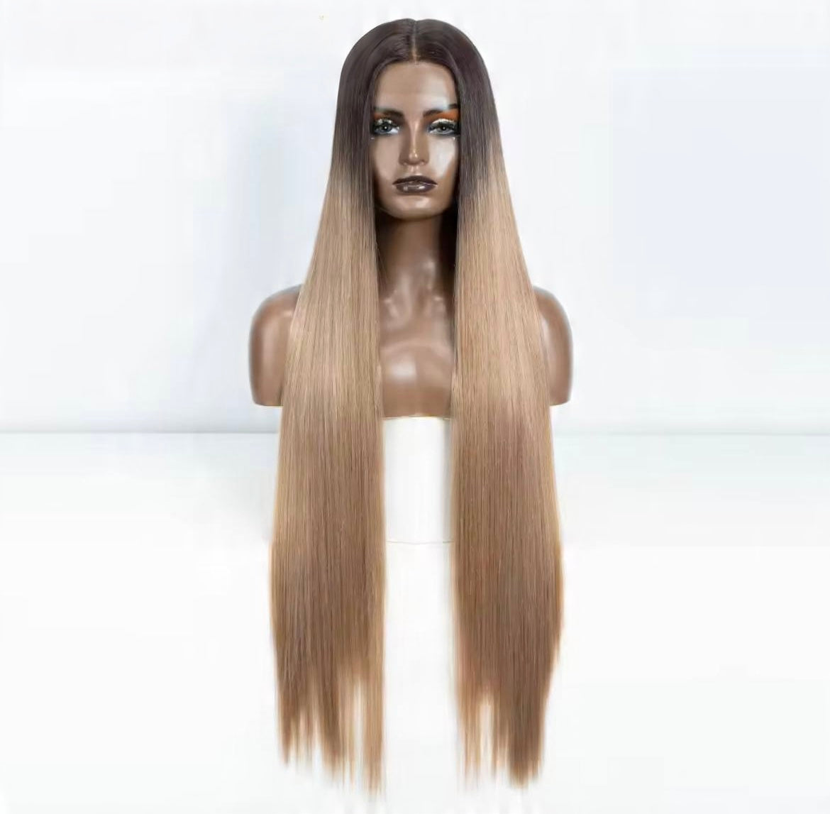 Blonde wig on a mannequin head against a white background